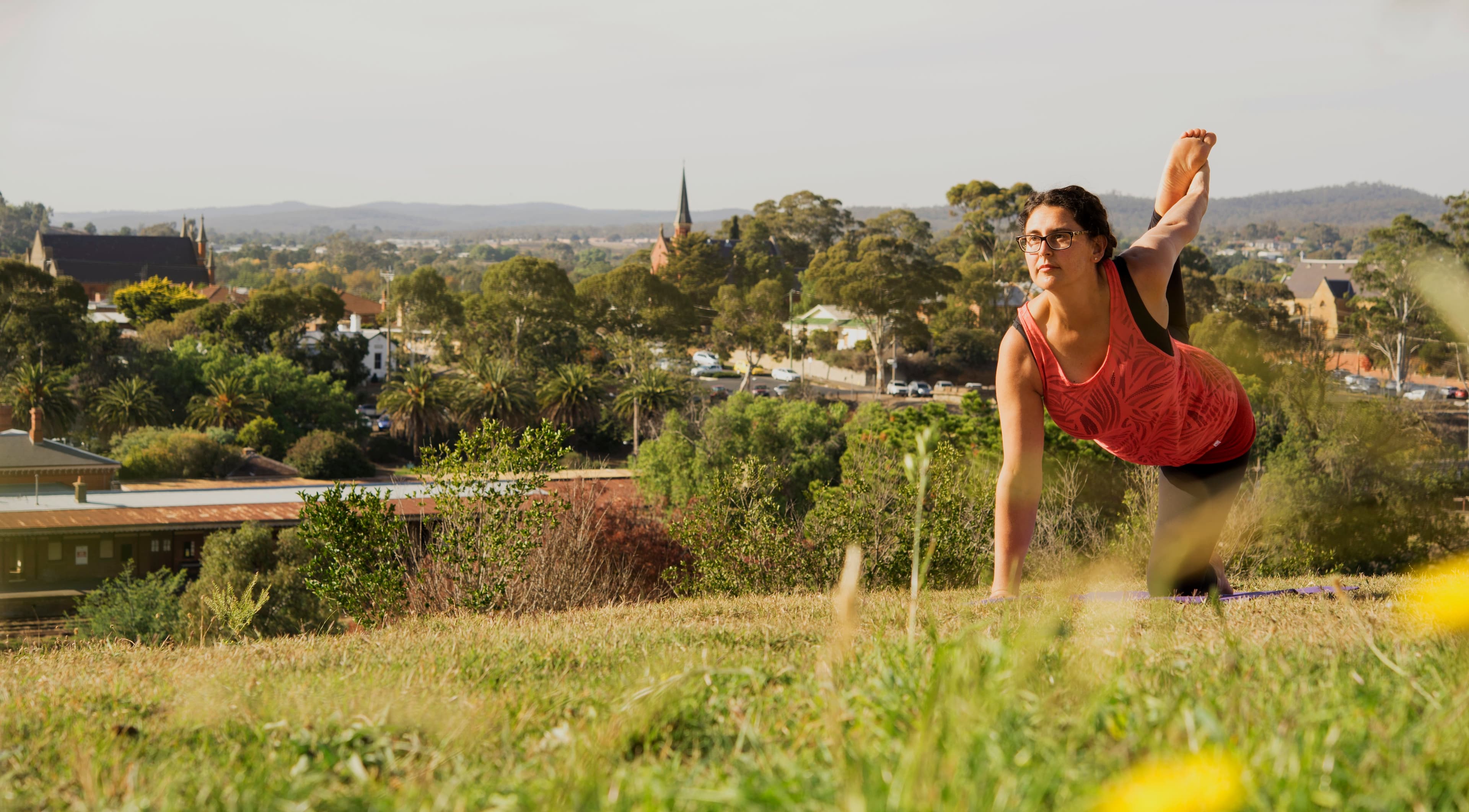 Jacqui practising yoga on a hilltop overlooking Castlemaine, Victoria